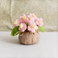 Macro detail of handmade crochet pink flowers in a rustic linen wrapped pot decoration - Pink Lucky Bag Multi-flower Puff Flower