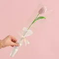 Handmade pink knitted tulip flower in gift wrap with love ribbon and romantic background - Pink Tulip