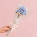 Handmade knitted blue lily flower with green stem in elegant gift wrap and ribbon - Blooming Tulip Light Blue