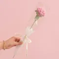 Handmade pink knitted rose flower in gift wrapping with love is eternal ribbon - Rose Pink