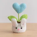 Handmade crochet white bunny potted plant with a light blue heart and green leaves - Heart Blue