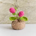 Handmade crochet pink flower potted plant with green leaves and a brown linen-style base - Rose Red Pine Cone Style