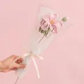 Handmade pink crochet rose bouquet with white wave wrapping and a love-themed ribbon - Tung Flower Pink