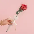 Handmade red knitted rose in clear wrap with a white ribbon saying Love Is Eternal - Wine Glass Rose Red
