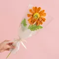 Handmade knitted orange daisy flower in romantic gift packaging with love ribbons - Gerbera Orange
