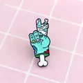 Blue zombie skeletal hand peace sign enamel pin with bandage and blood details - Zombie Hand Victory Style (XZ0476)