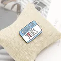 Macro shot of Hello I'm Yours enamel brooch pin on linen pillow with light blue border - Light Blue Yours Name Tag (XZ1108)