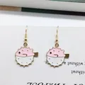 Detail of pink pufferfish earrings with golden hooks on white paper background - Pink Pufferfish Style (EAR2598)