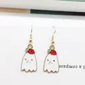 Close-up of cute ghost earrings with strawberry motif and golden metal hooks - Strawberry Ghost Style (EAR2599)