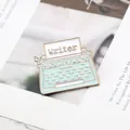 Close-up of mint green vintage typewriter enamel pin with golden Writer text detail - Typewriter Style (MZ006)