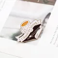 Detailed view of enamel brooch featuring a pen, book, and 'I Should Be Writing' quote - Coffee and Book Style (MZ007)