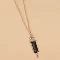 Macro detail of medical syringe pendant featuring black enamel and gold scale marks - Black Syringe Style (XL730)