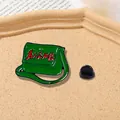 Macro shot of retro green enamel messenger bag brooch with red star and Chinese calligraphy - Green Messenger Bag Style (CZ0137)