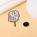 Detailed view of an elegant fan-shaped enamel pin with floral patterns and calligraphy - Pink Flower Round Fan Style (CZ0316)