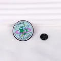 Detail of a Space Explorer enamel pin with a smiling earth and star ring on white fabric - Cz0406-2