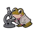 Detailed view of enamel pin featuring a cartoon frog scientist using a microscope - Microscope Frog Style (QHXZ4241)