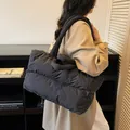Quilted black puffer tote bag in lightweight nylon, versatile for daily commuting and wear - Black