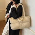 Quilted down-style tote bag in cream beige worn by a model for daily commuting - Khaki