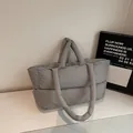 Chic grey quilted puffer tote bag with padded handles for winter commuter style - Gray