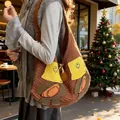 Brown knitted tote bag with cute cartoon bear embroidery shown in outdoor autumn scene - Brown