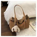 Caramel large tote bag with white rabbit plush pendant in minimalist bedroom setting - Brown with Pendant