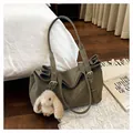 Olive green frosted tote bag with plush bunny charm in a cozy indoor setting - Green with Charm