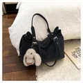 Matte black tote bag with silver eyelets and a cute plush rabbit charm accessory - Black With Pendant
