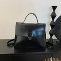 Fashionable black faux leather messenger backpack with metal buckle and top handle - Black Without Pendant
