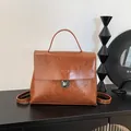 Vintage brown oil leather messenger backpack with classic metal clasp and top handle - Brown Without Pendant