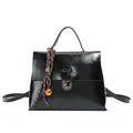 Glossy black leather messenger bag with woven charm and adjustable strap variant - Black With Pendant