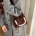 Brown suede bucket bag with faux fur trim pocket and embroidered detail for autumn winter - Coffee
