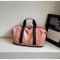 Bolso de viaje rosa de gran capacidad con asas negras y tejido impermeable suave - Rosa