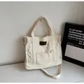 Creamy white canvas tote bag with adjustable shoulder strap and leather logo patch - Off White