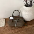 Olivgrüne Wildleder-Tragetasche mit Plüschanhänger auf Holztisch, Winter-Minimalismus - Mit Anhänger / Grün