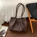 Retro dark brown pebbled leather tote bag with long handles and buckle strap detail - Brown