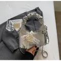 Detail of silver pleated handbag featuring heart pearl and lace bow charm accessories - Silver with Charm