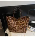 Retro leopard print suede tote bag with brown slim handles in a lifestyle setting - Brown