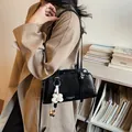 Chic black pleated PU leather shoulder bag for women with a white flower charm accessory - With Pendant / Black