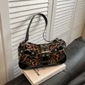 Borsa a spalla vintage leopardata con borchie argento e grande fibbia chic - Nero
