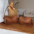 Classic brown leather shoulder bags set with adjustable straps on a wooden table - L / Lazy Brown