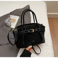 Modern black tote bag with white stitching and golden buckle detail for elegant daily use - Black