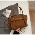 Dark brown textured leather handbag with pleated design and metallic buckle detail - Brown