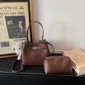 Dark brown pebble leather bucket bag with a plush charm and matching pouch - With Pendant / Coffee