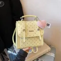 Vintage yellow backpack with brown polka dots and a cute pink heart charm detail - Yellow