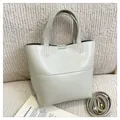 Minimalist light gray faux leather tote bag with top handles and golden hardware details - Light Gray