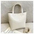Minimalist beige PU leather tote bag with sturdy handles and adjustable shoulder strap - White