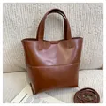 Minimalist brown tote bag in synthetic leather with adjustable shoulder strap and top handles - Brown
