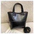 Minimalist black bucket bag in glossy synthetic leather with detachable shoulder strap - Black