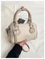 Fashionable beige canvas and leather boston barrel bag with adjustable strap and top handle - Beige