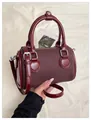 Mini Boston handbag in deep burgundy featuring textured fabric and leather contrast - Red